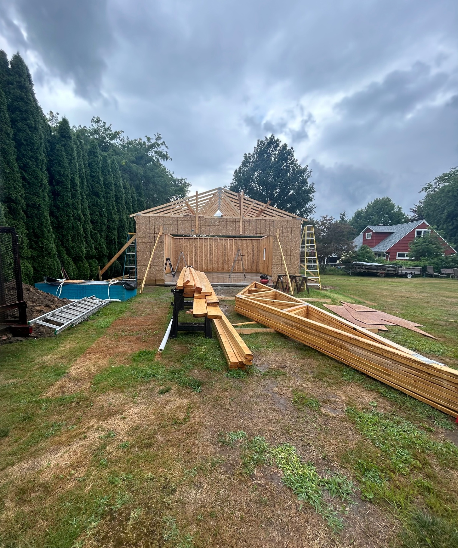 Pole barn framing and roof trusses going up on site