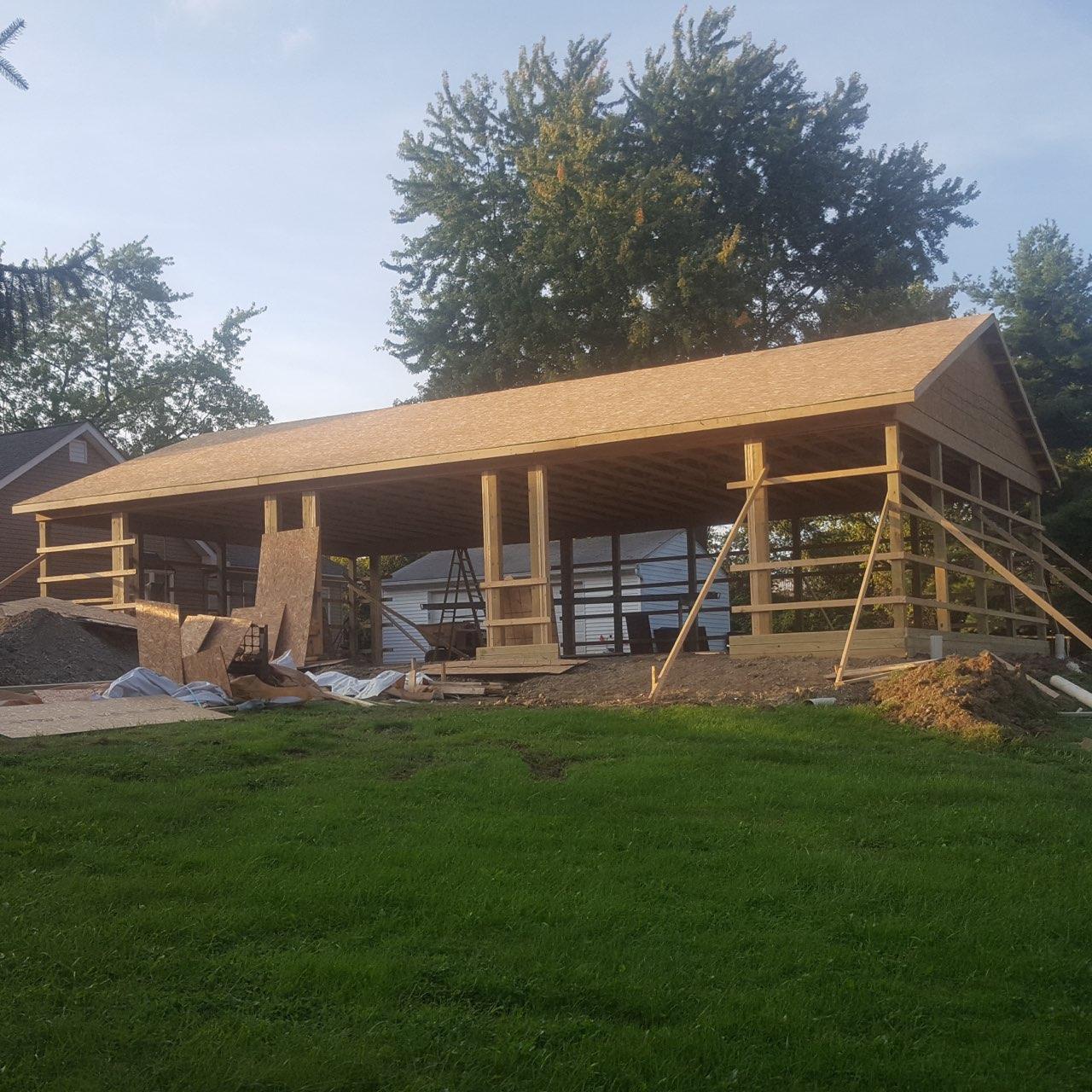 Barndominium mid-build showing framed roof and open bay structure