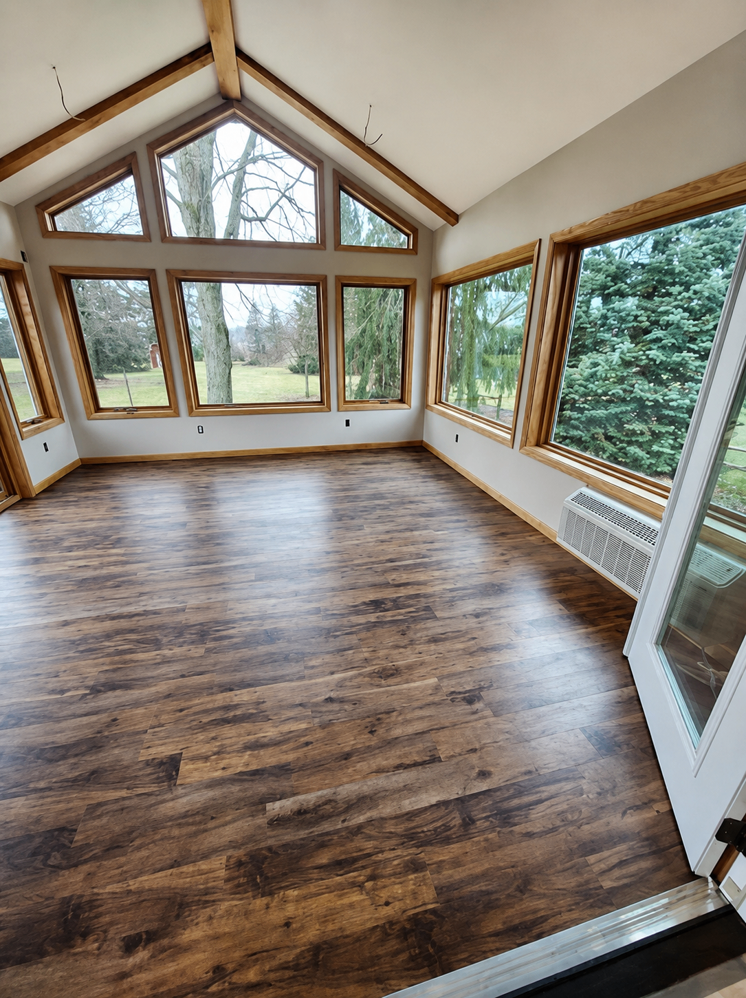Sunroom addition with vaulted wood-beam ceiling and large windows