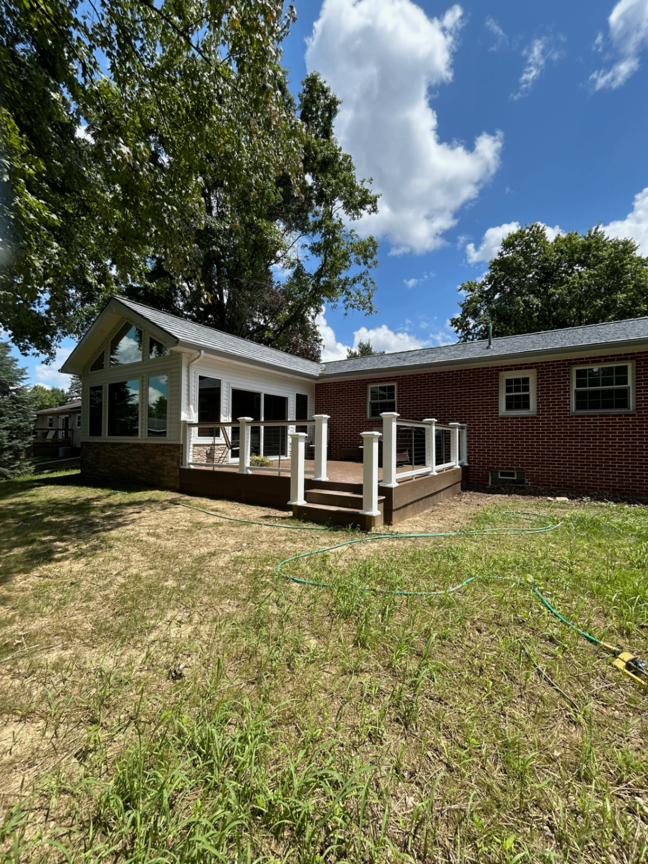 Brick ranch home with a new composite deck and cable railings