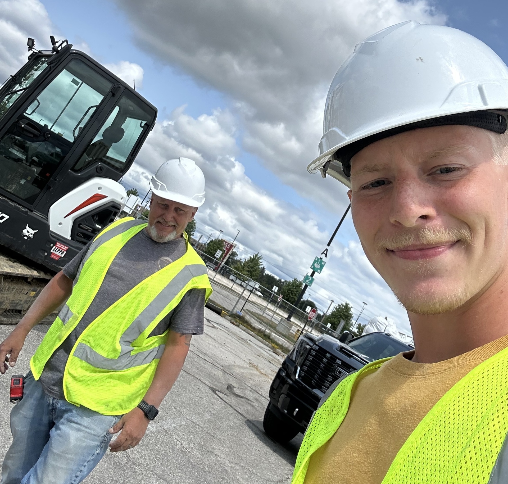 Lou and Louie Reynolds on a Northeast Ohio job site in hard hats and safety vests